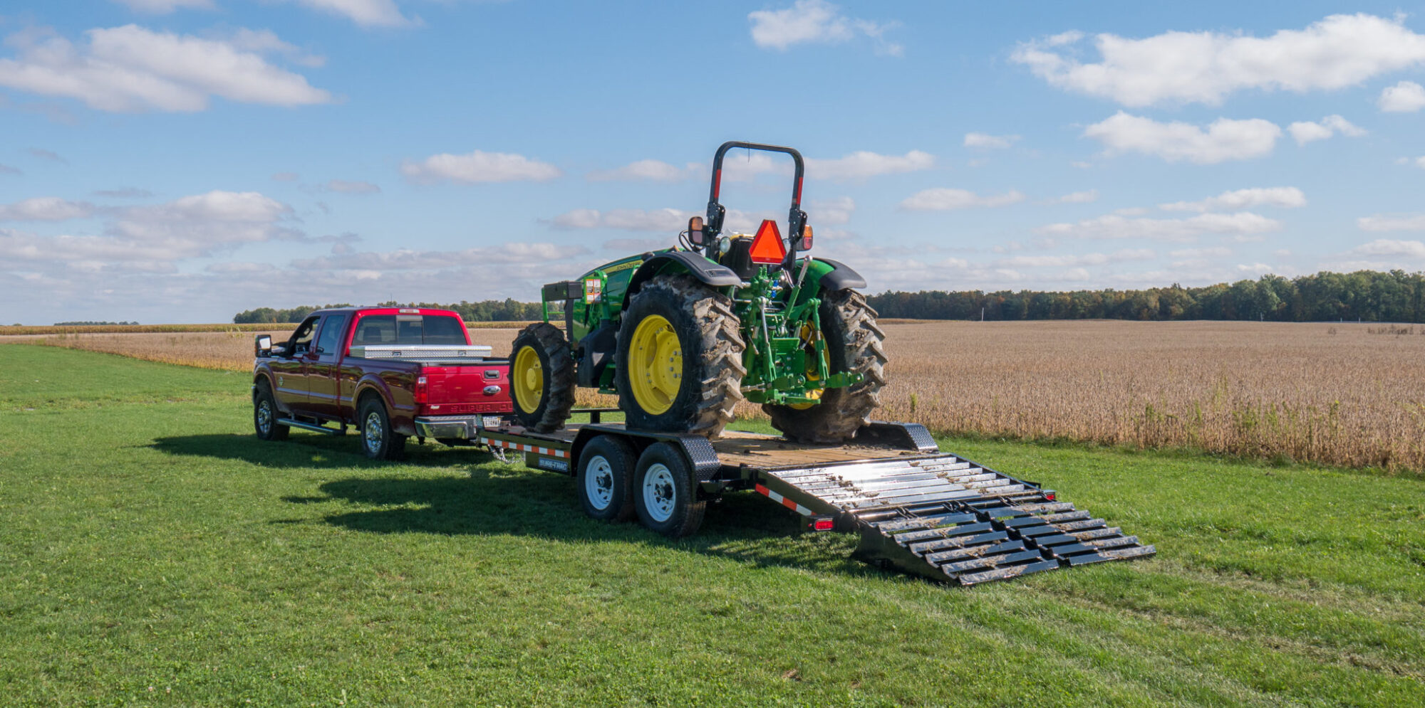 view of the Universal Ramp Equipment Trailer with a tractor loaded onto it