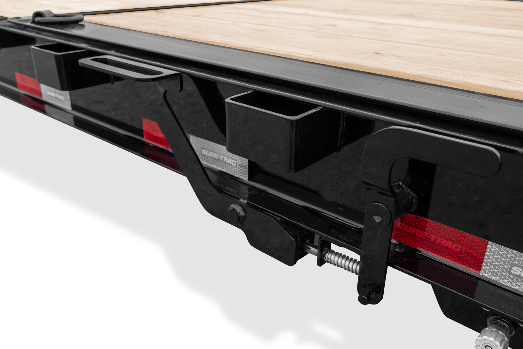 Pro Series Tilt Bed Trailer | Side, tilted, Trailer with reflective tape, close-up of Tilt Latch