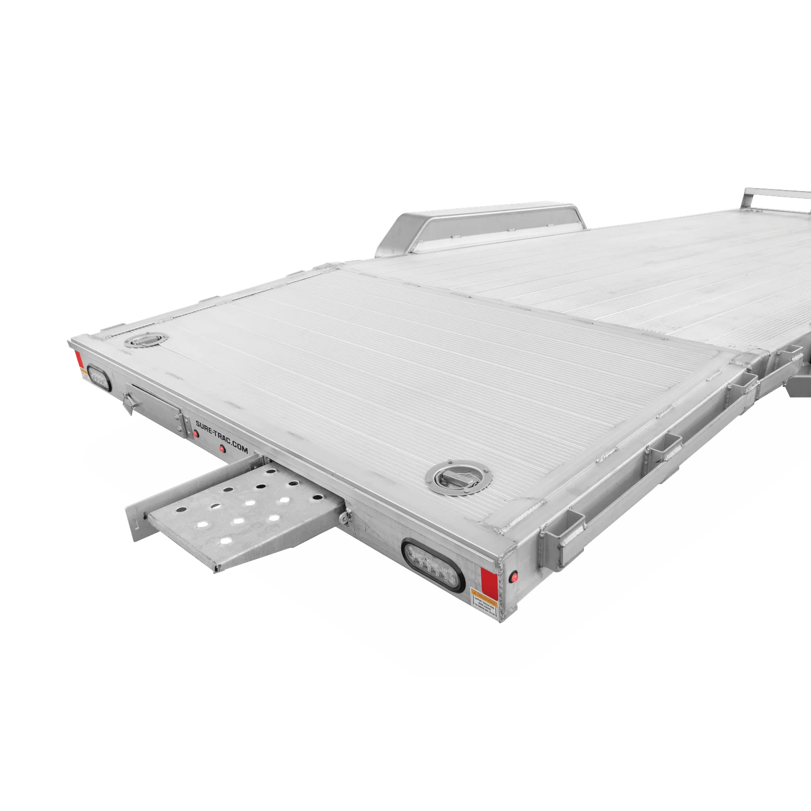 Silver aluminum flatbed trailer with rear loading ramp extended and visible taillights and tie-down points (Sure-Trac). - Informative image for a trailer product page.