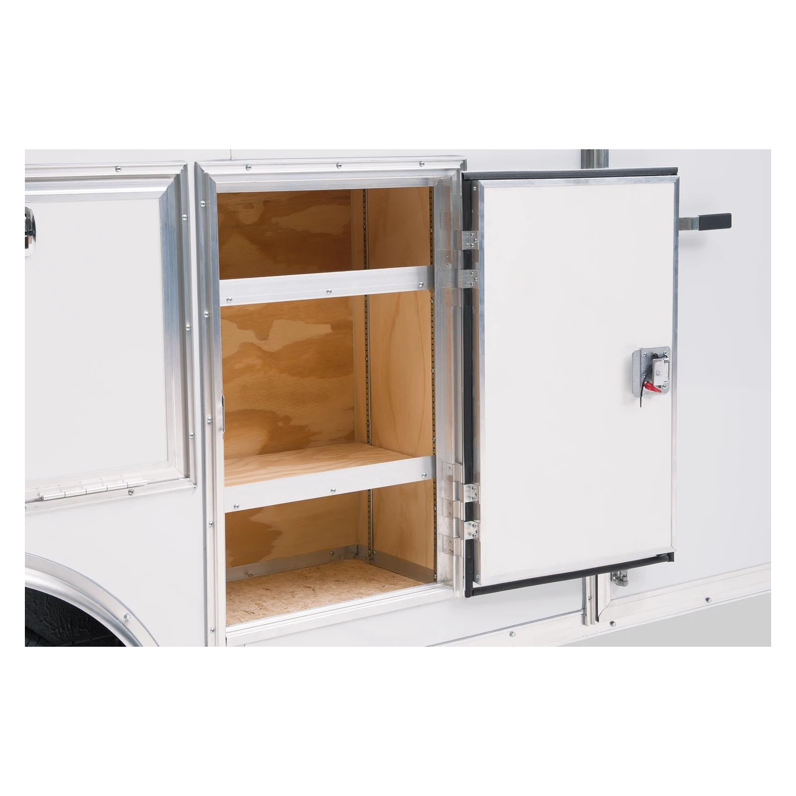 Open side storage compartment of a silver trailer showing wooden shelves inside.