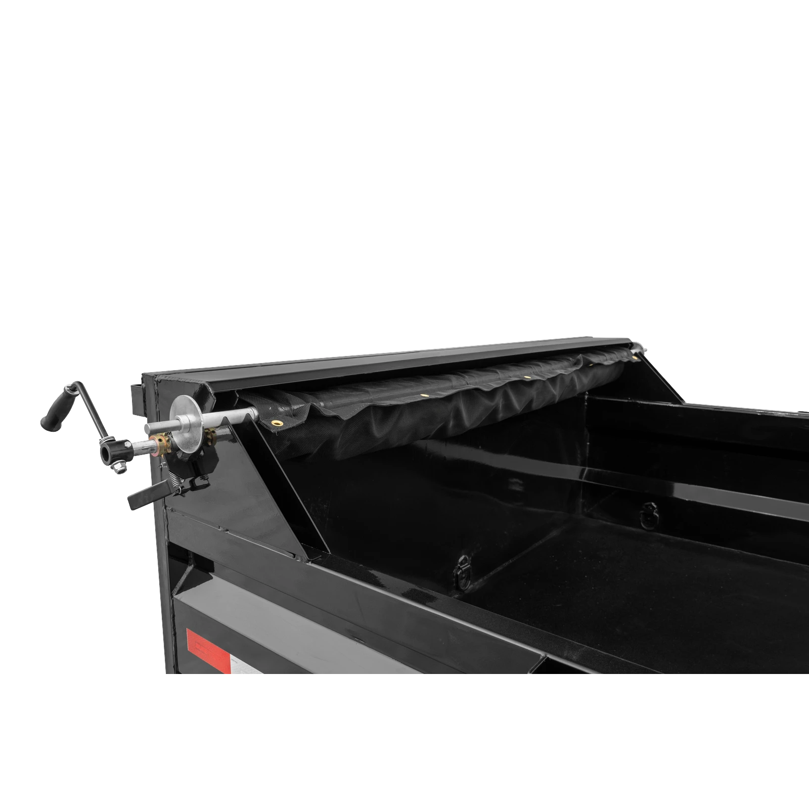 Close-up of a black dump truck bed with a hydraulic/tipping mechanism and side crank handle visible on the left